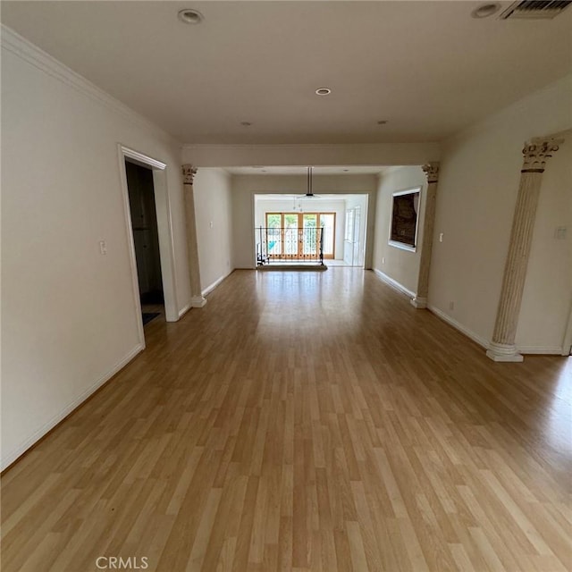 empty room with light hardwood / wood-style flooring and crown molding