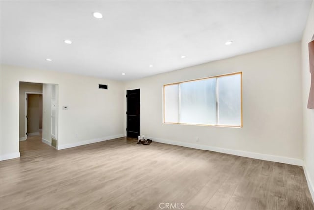 unfurnished room featuring light hardwood / wood-style floors