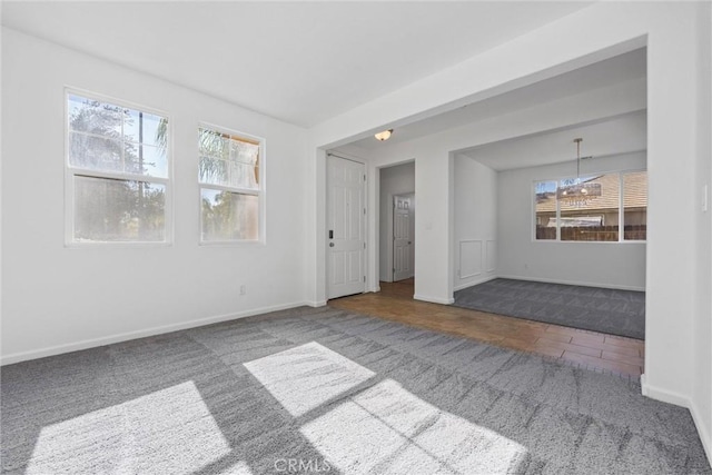 carpeted spare room featuring a wealth of natural light