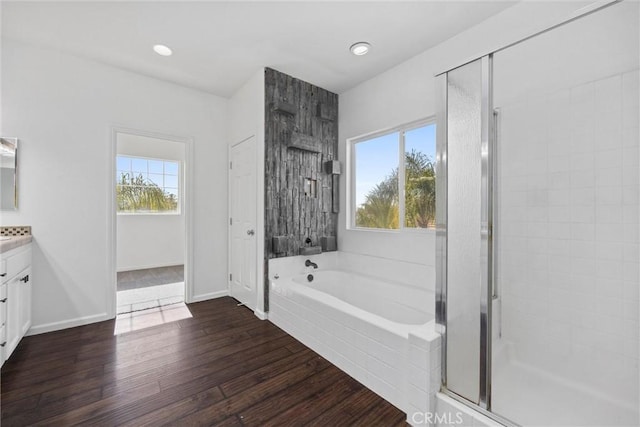 bathroom with vanity, a healthy amount of sunlight, wood-type flooring, and shower with separate bathtub