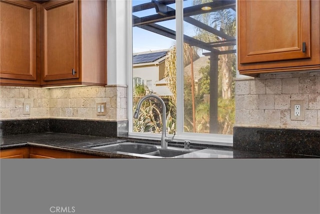 kitchen featuring decorative backsplash and sink