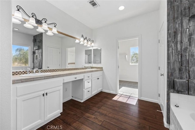 bathroom featuring vanity, decorative backsplash, and wood-type flooring