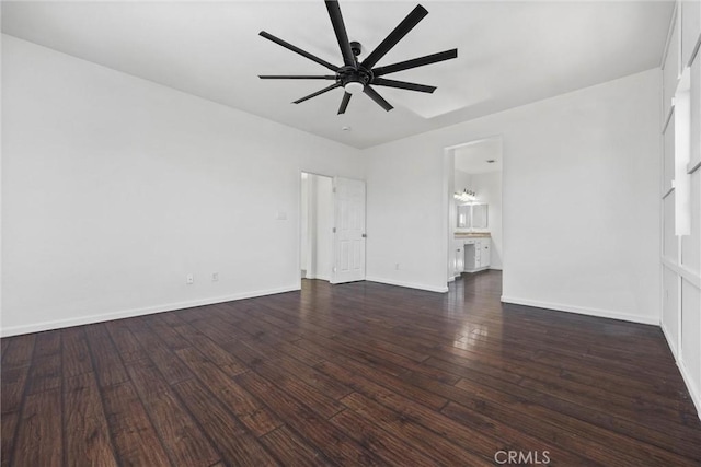 unfurnished room with ceiling fan and dark wood-type flooring