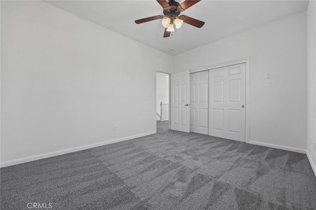 unfurnished bedroom featuring ceiling fan, a closet, and carpet