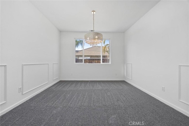 carpeted empty room with a notable chandelier