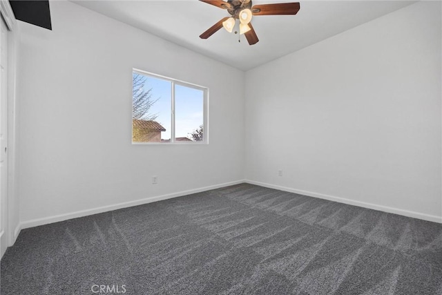 carpeted spare room with ceiling fan