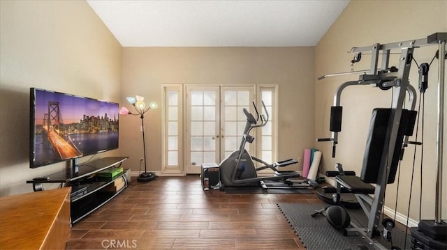 exercise area featuring dark hardwood / wood-style flooring and vaulted ceiling