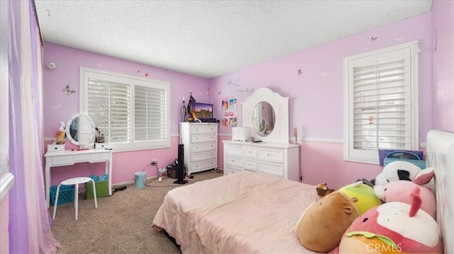 bedroom featuring a textured ceiling and light colored carpet