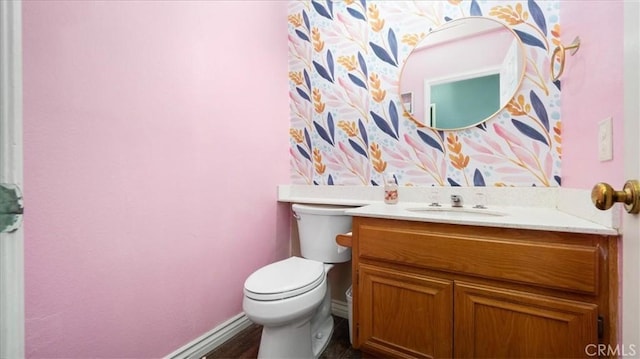 bathroom featuring vanity and toilet