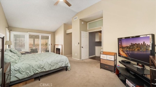 bedroom with ceiling fan, light colored carpet, and vaulted ceiling