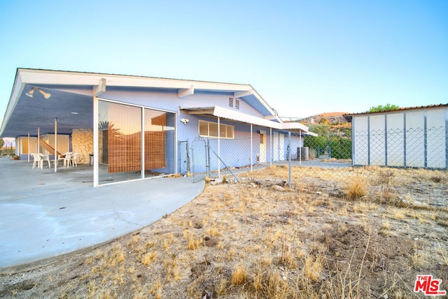 rear view of house with central AC unit