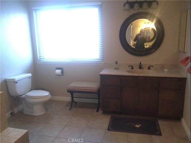 bathroom featuring tile patterned flooring, vanity, and toilet