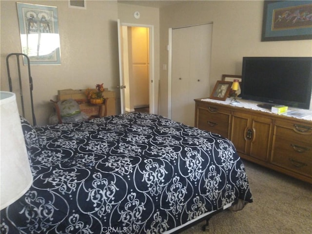 bedroom with carpet and a closet