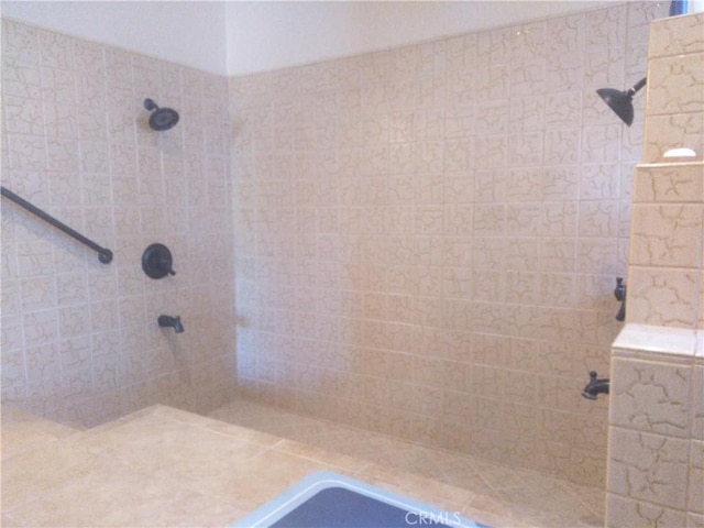 bathroom with a tile shower