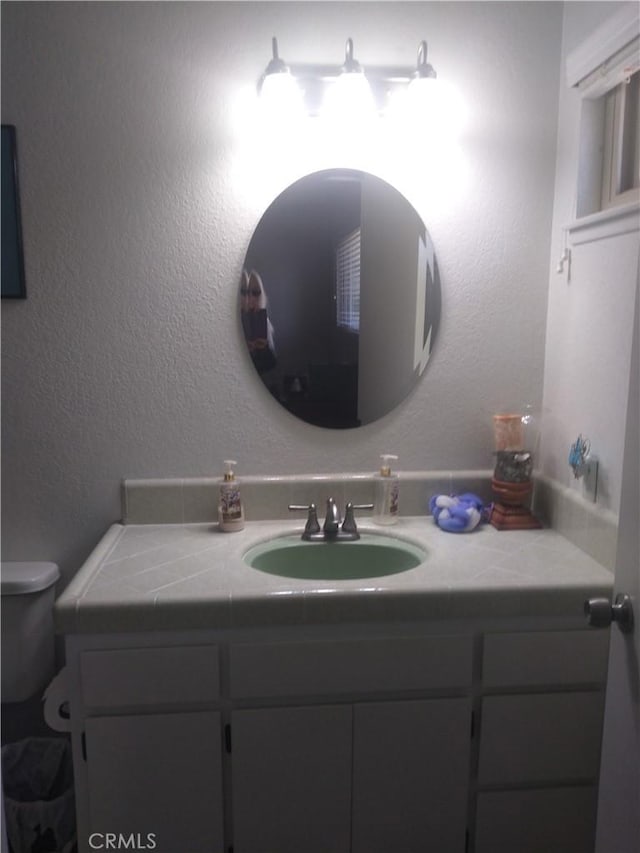 bathroom with vanity and toilet