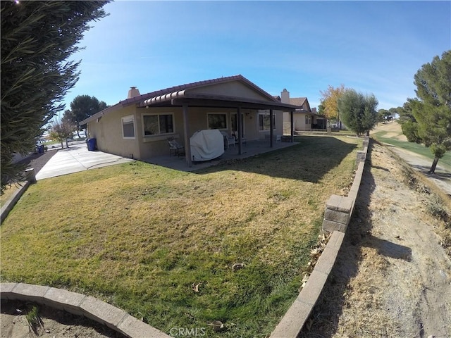 exterior space featuring a yard and a patio area