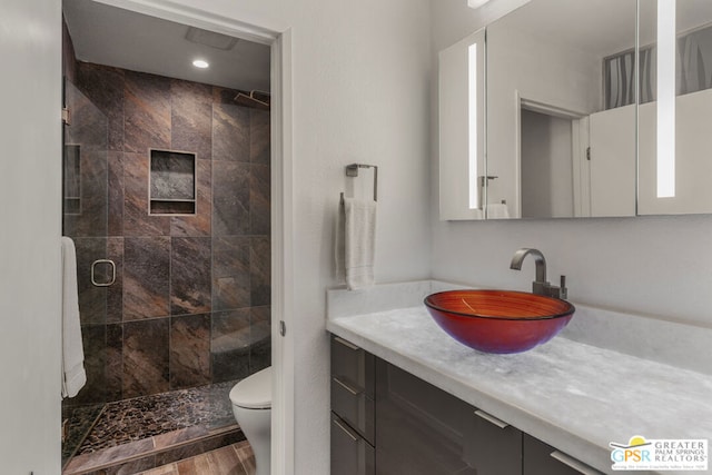 bathroom featuring an enclosed shower, vanity, toilet, and wood-type flooring