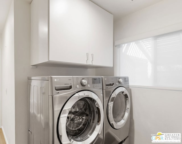 laundry room with cabinets and washing machine and dryer