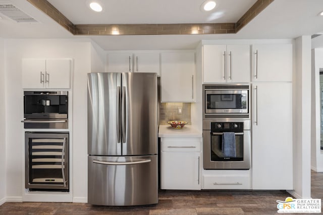 kitchen featuring white cabinetry, stainless steel appliances, wine cooler, dark hardwood / wood-style floors, and decorative backsplash