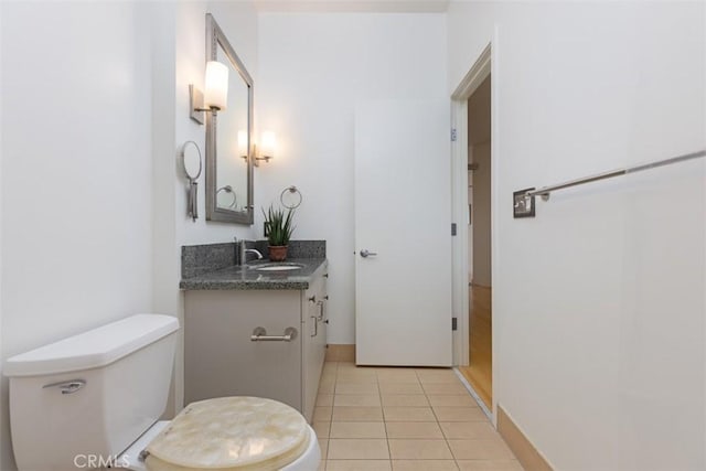 bathroom featuring tile patterned floors, vanity, and toilet