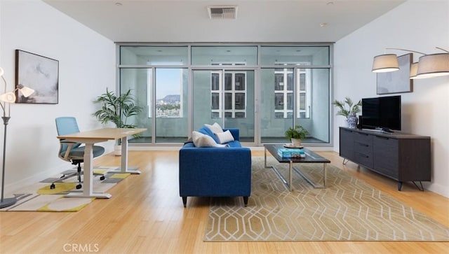 interior space featuring light hardwood / wood-style floors and floor to ceiling windows