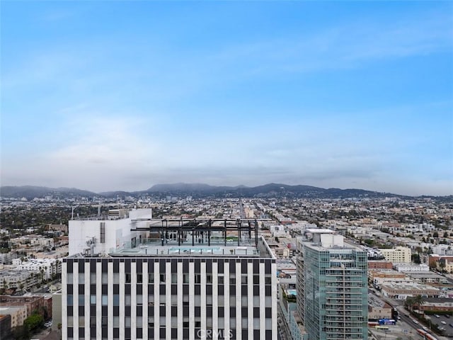 property's view of city with a mountain view