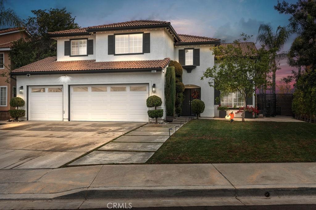 mediterranean / spanish-style house featuring a lawn and a garage