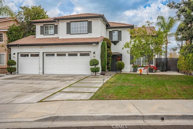 mediterranean / spanish house featuring a front yard and a garage