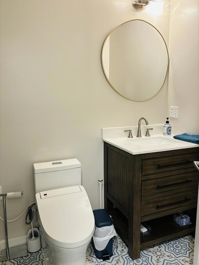 bathroom with tile patterned flooring, vanity, and toilet