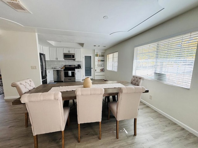 dining space featuring hardwood / wood-style flooring