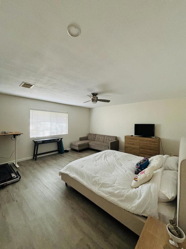 bedroom featuring a textured ceiling, hardwood / wood-style flooring, and ceiling fan