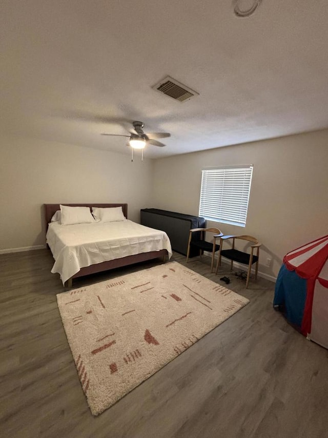 bedroom featuring ceiling fan and dark hardwood / wood-style floors