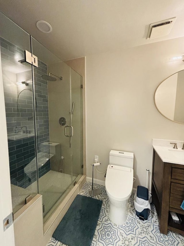 bathroom featuring an enclosed shower, vanity, toilet, and tile patterned floors