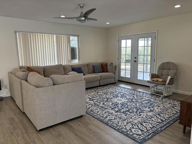 living room featuring hardwood / wood-style flooring, ceiling fan, and french doors