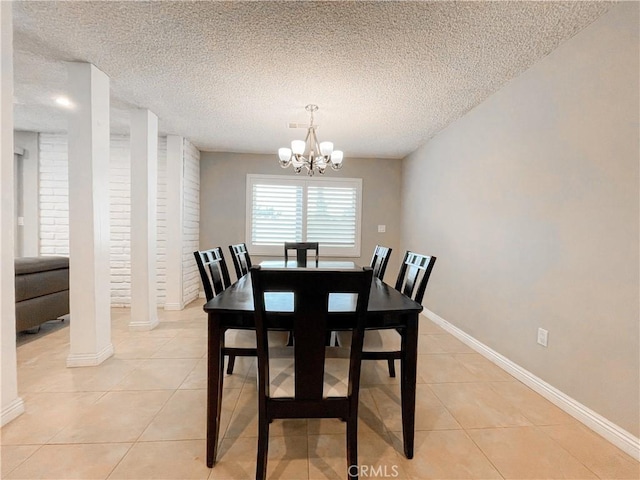 dining room featuring light tile patterned floors, a textured ceiling, and an inviting chandelier