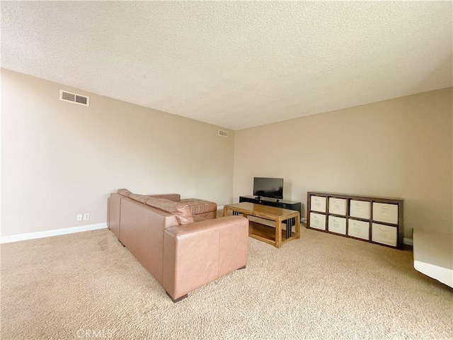 carpeted living room with a textured ceiling