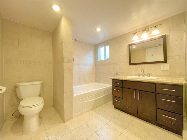 bathroom featuring tile patterned floors, vanity, tile walls, toilet, and a tub