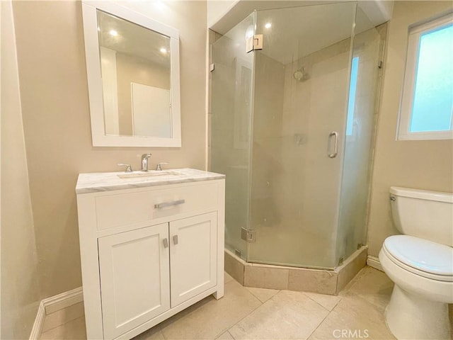 bathroom with tile patterned flooring, vanity, toilet, and a shower with door