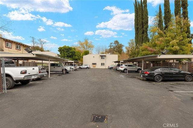 view of parking / parking lot featuring a carport