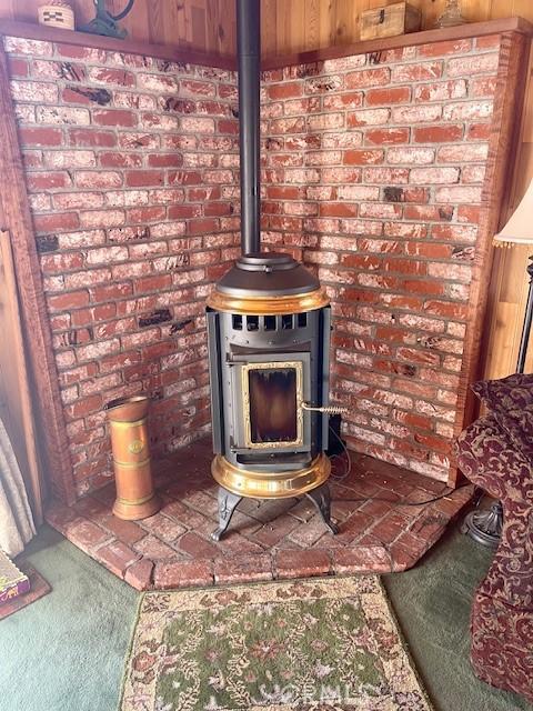 details with carpet floors and a wood stove