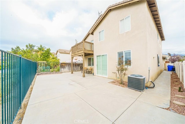 rear view of house featuring a patio area and cooling unit