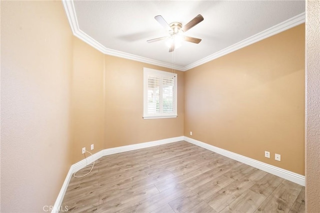 empty room featuring ceiling fan, crown molding, and light hardwood / wood-style flooring