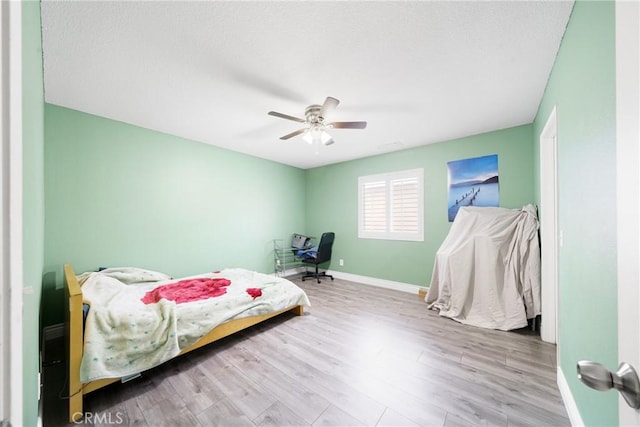 bedroom featuring ceiling fan and light hardwood / wood-style floors