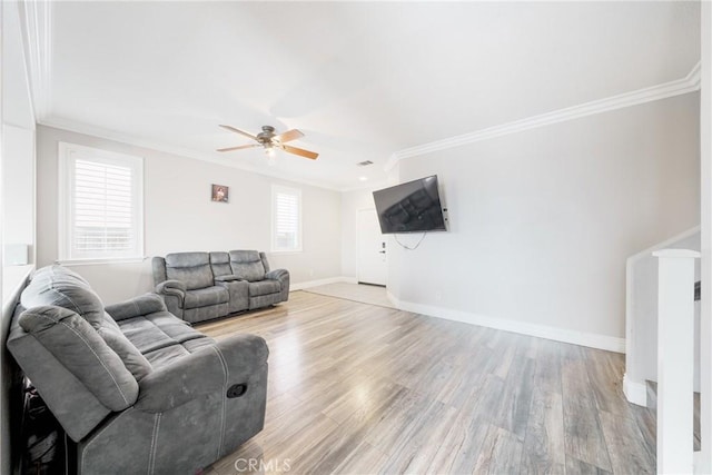 living room featuring ornamental molding, ceiling fan, and light hardwood / wood-style floors