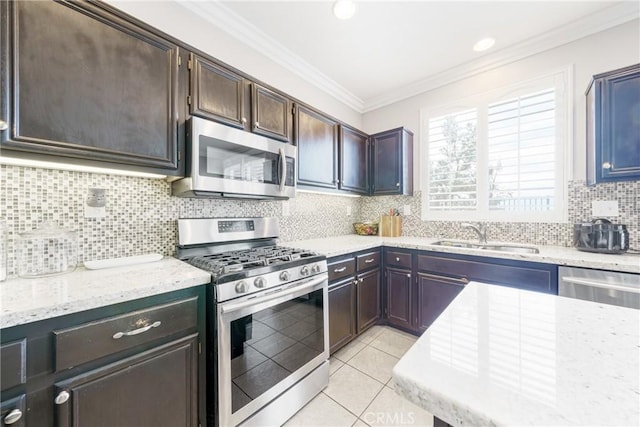 kitchen with stainless steel appliances, light tile patterned floors, decorative backsplash, and sink