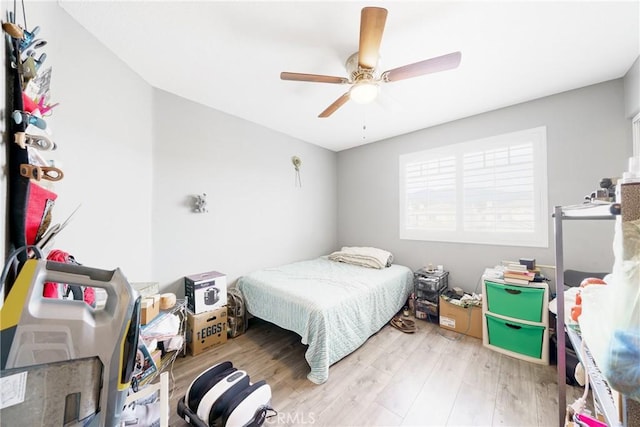 bedroom with ceiling fan and light hardwood / wood-style floors