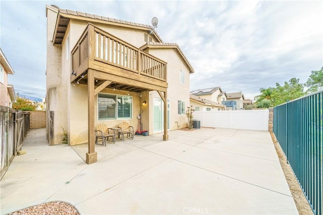 rear view of house featuring cooling unit and a patio area