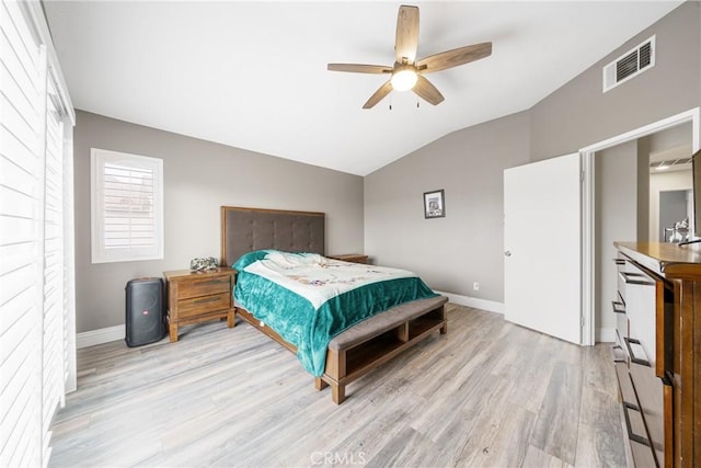 bedroom with ceiling fan, light wood-type flooring, and lofted ceiling