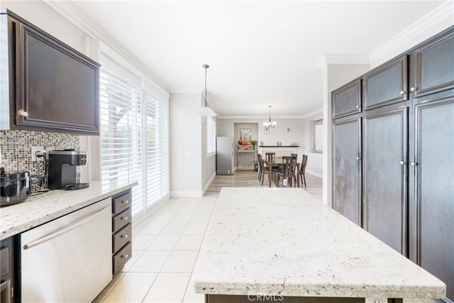 kitchen featuring hanging light fixtures, a center island, decorative backsplash, appliances with stainless steel finishes, and ornamental molding