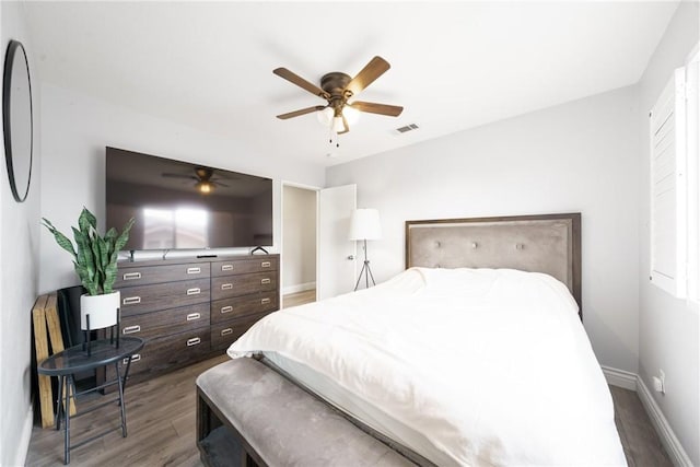 bedroom featuring ceiling fan and dark wood-type flooring